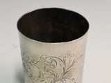 a silver cup that has a design on it