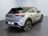 the rear end of a silver suv parked in a room