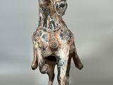 statue of a man on a horse on a wooden base