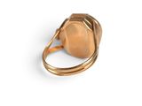 a close up of a gold ring on a white surface