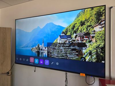 a flat screen tv hanging on a wall in a room