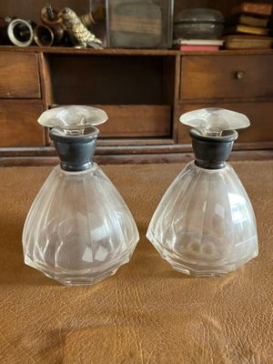 two clear glass vases sitting on top of a wooden table