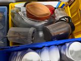a blue bin filled with plastic cups and plates
