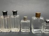several glass bottles are lined up in a row on a table
