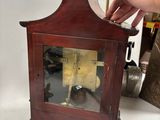a small wooden clock that is sitting on a table