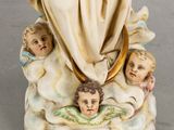 a figurine of an angel with angels on it
