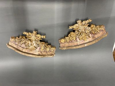 two pieces of carved wood on display on a table