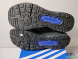 the soles of a pair of black and blue shoes on top of a blue and white box