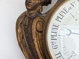a clock that is hanging on the wall with a woman on it