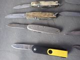 several different types of knives are lined up on a table