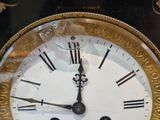 a clock with roman numerals on the face of it