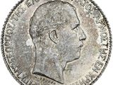 une vieille pièce d'argent sur laquelle figure le profil d'un homme