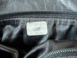 the inside of a black leather purse with a label on it