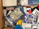 a cardboard box full of electronic devices and other items