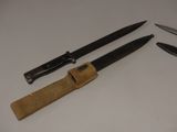 two knives and a sheath on the table