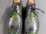 the shoes are green and black with a brown sole