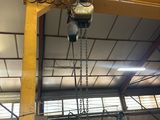 a crane that is hanging from the ceiling in a building