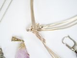 many different necklaces that are laying on a table
