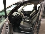 the interior of a car with the door open and the driver ' s seat down