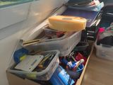 a desk with a drawer full of items on it