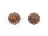 a pair of carved wood knobs on a white background