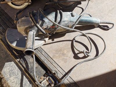 a drill on the ground next to a pair of scissors
