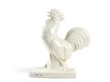 a white statue of a rooster on a stand