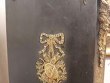 a black and gold cabinet with gold decorations on it