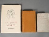 three books are sitting on a table next to each other