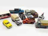 a lot of toy cars and trucks on a white surface