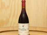 une bouteille de vin posée sur un tonneau