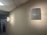 a man standing in the hallway of an office building