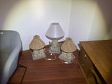 three lamps that are sitting on the floor next to a chair