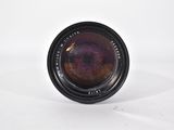 a close up of a camera lens on a white surface