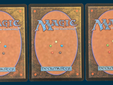 three decks of magic the gathering are shown in three different positions