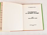 an open book on a white table with a green border