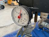 a close up of a pressure gauge on a blue tank