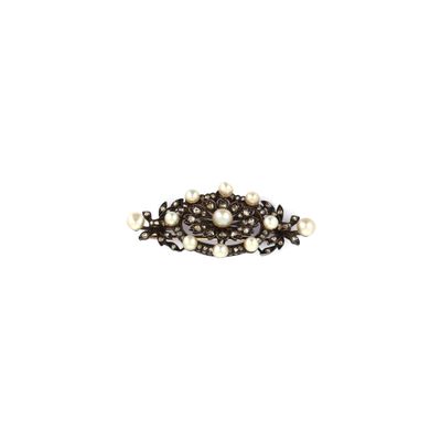 a close up of a brooch with pearls on a white background