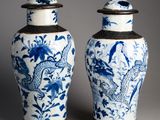 pair of blue and white vases with birds and flowers on them