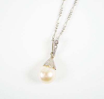 a white pearl and diamond pendant on a silver chain