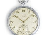 a close up of a pocket watch on a white surface