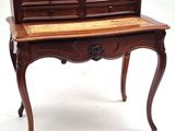 a small desk with a drawer on top of it