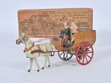 a toy horse pulling a carriage with a man on it