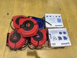 several red and black speakers sitting on top of a wooden floor
