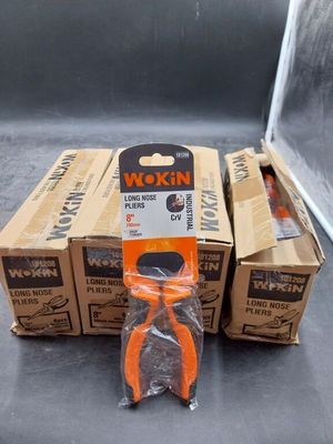three boxes of wokin pliers sitting on top of a table