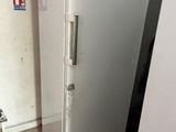 a white refrigerator in the corner of a kitchen