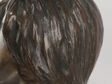 a bronze statue of a man with a short hair