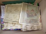 a cardboard box filled with lots of buttons and stickers
