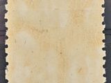 a piece of parchment paper with holes cut into it on a wooden surface