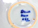 a close up of a white vase with blue writing on it